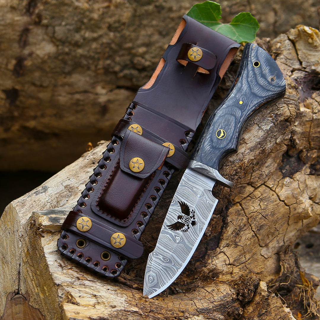 Knife with leather sheath on a wooden surface