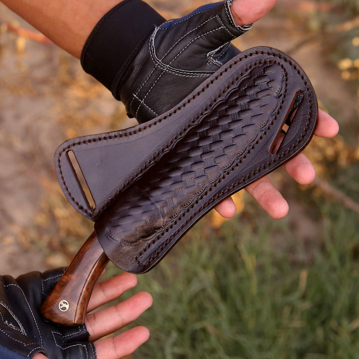 Close-up of a leather boot sole with a textured pattern held by a person.