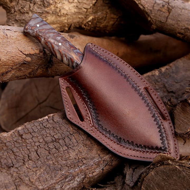 Brown leather knife sheath on a wooden background