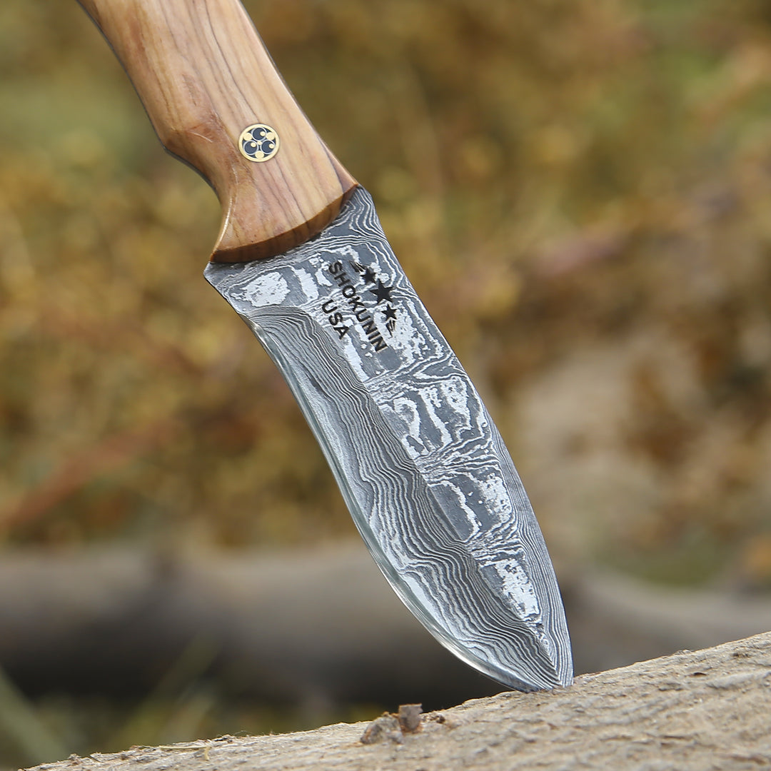 Forked blade knife with wooden handle on a natural background