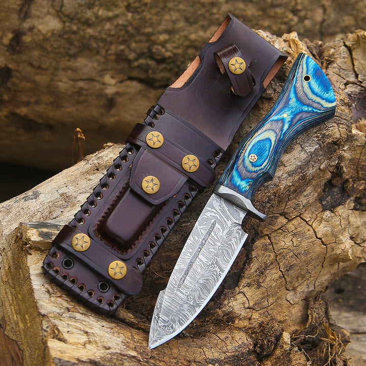 Decorative knife with a blue and silver handle on a wooden surface